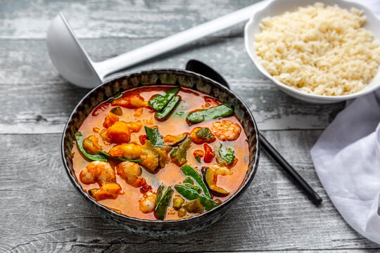 Red curry with sweet potato, yellow and red bell pepper, zucchini, sugar pea, shrimps and rice
