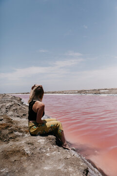Namibia, Walvis Bay, woman sitting at Pink Lagoons