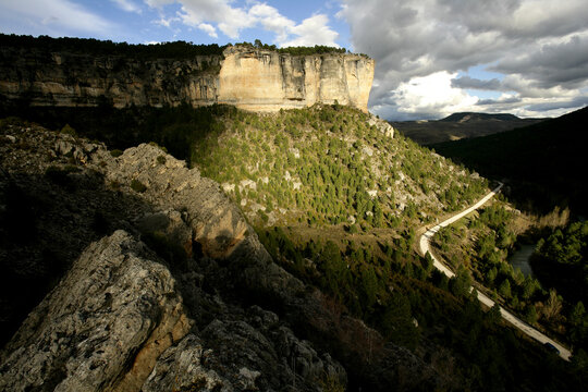 Spain, Province of Guadalajara, Winding road stretching across valley in Alto Tajo Nature Reserve