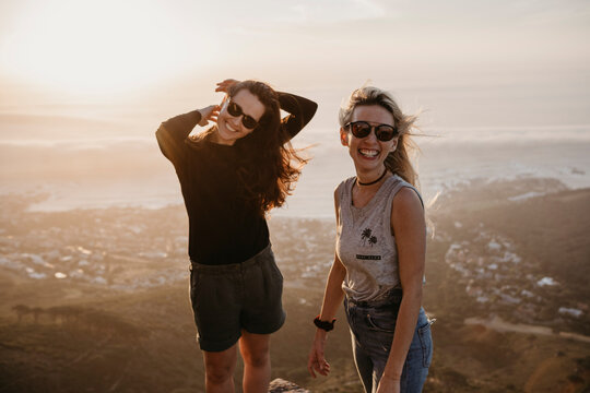 South Africa, Cape Town, Kloof Nek, portrait of two happy women at sunset