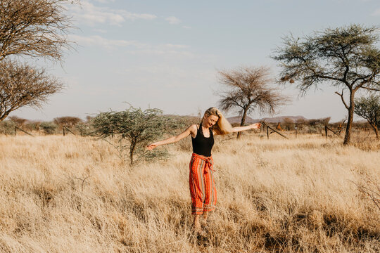 Africa, Namibia, blonde woman in grassland