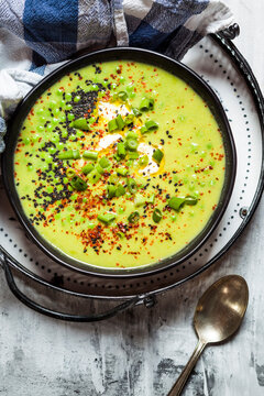 Bowl of Fresh green pea soup with spring onions