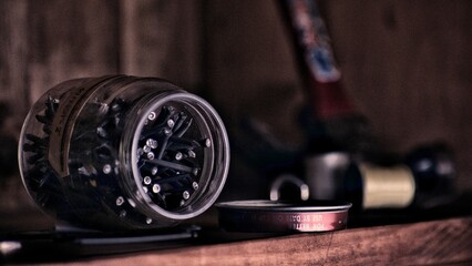 Jar of nails sits open on the counter.