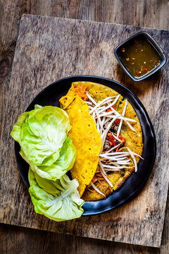 Banh xeo with lettuce and Nuoc Cham dipping sauce