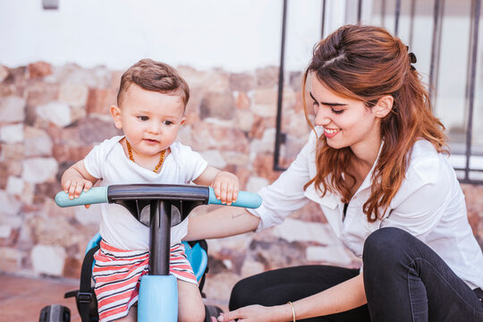 Mother with her son on tricycle