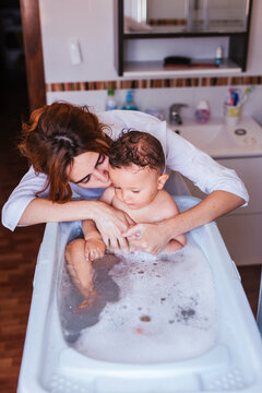 Mother bathing her little son