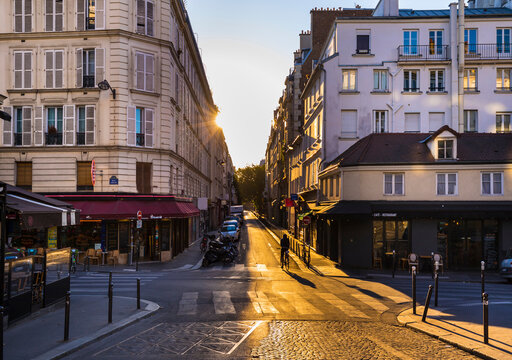 Road by buildings against clear sky during sunset, Paris, France