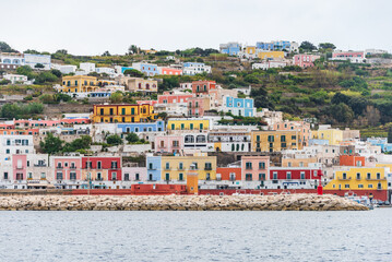 The port of the Ponza island in summer. Coloured houses, boats, ferry in the harbour of island of...