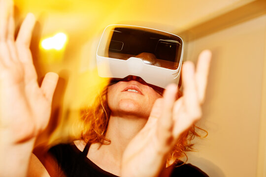 Close-up of woman looking through virtual reality simulator at home