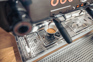 Professional coffee machine brewing espresso in coffee shop