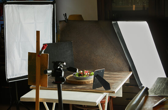 Set food photographer equipment for shooting recipes, softboxes and tripods, reflectors and backgrounds
