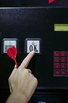Close-up of woman's hand switching on electronic dartboard