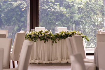 Main table at a wedding reception with beautiful white flowers