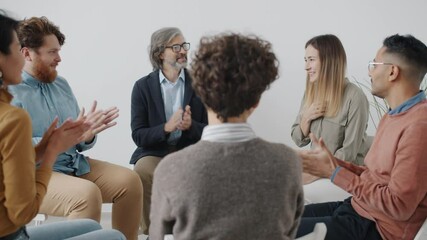Diverse group of people are speaking sharing problems clapping hands during therapy session. Psychological support and community concept.