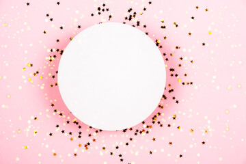 Golden stars sparkles confetti under white podium for cosmetics showcase on pink pastel trendy...