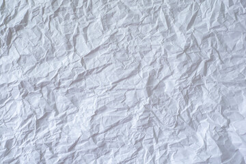 Large format crumpled white paper as a background.