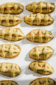 Directly above view of fresh Mona De Pascua pastries on white table