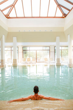 Man relaxing in swimming pool of a spa