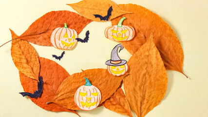 A Halloween-themed cartoon with paper pumpkins, leaves and bats.