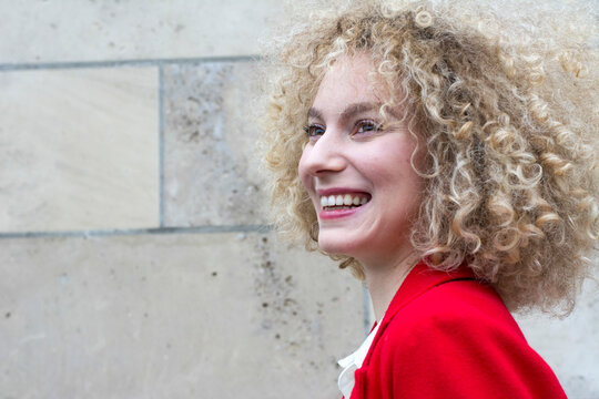 Portrait of laughing blond woman with ringlets