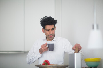 Portrait of businessman having breakfast at home