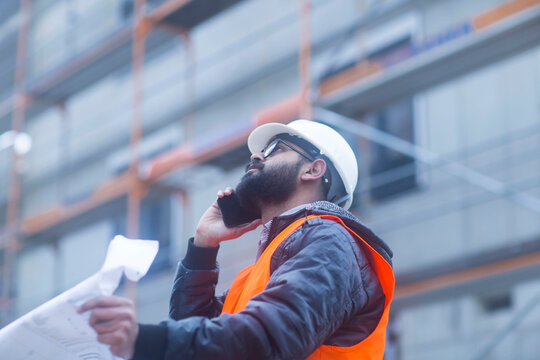 Construction engineer on the phone at construction site