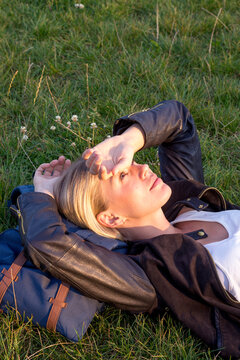 Woman lying on a meadow in a park relaxing