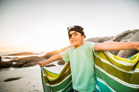 Boy dressed up as pirat on the beach
