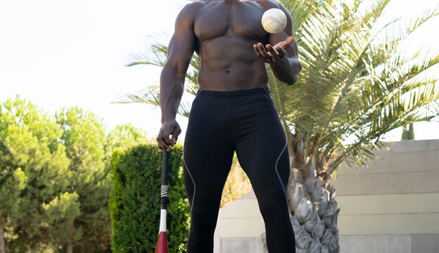 Male athlete playing with baseball in park
