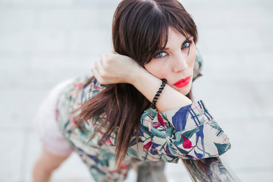 Portrait of young woman posing wearing patterned blouse