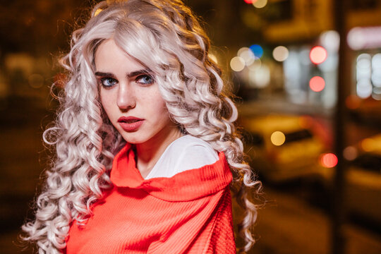 Portrait of young woman on the street at night