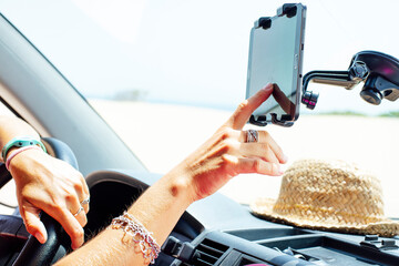 Close-up of woman using navigation on smart phone in van