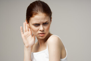 sick woman poor hearing disorders in white t-shirts studio treatment