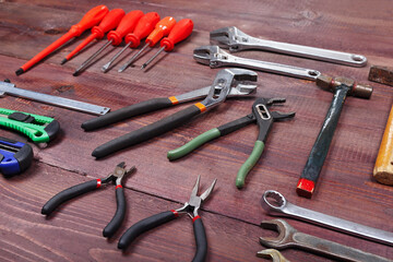 Plakat Diverse of plumbing tools for repair work on wooden background.