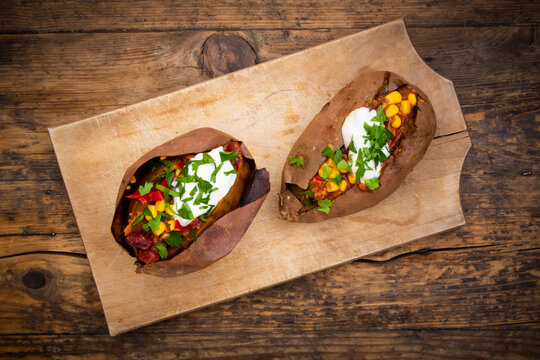 Sweet potato kumpir with chili con carne, sour cream and coriander