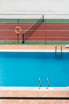 Empty swimming pool and tennis court