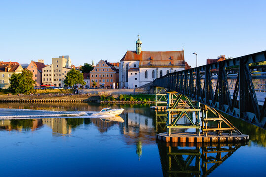 St. Oswald Church with Eiserner Steg bridge over Danube River in Regensburg, Upper Palatinate, Bavaria, Germany