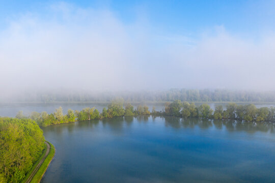Morning fog at Altheim reservoir, Isar, near Landshut, Bavaria, Germany, drone shot