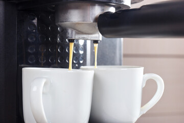 Making two cups of espresso in horn coffee maker.