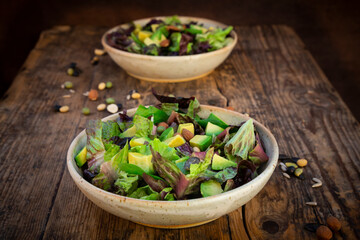 Various leaf salad with avocado, roasted seeds, almonds and soy beans