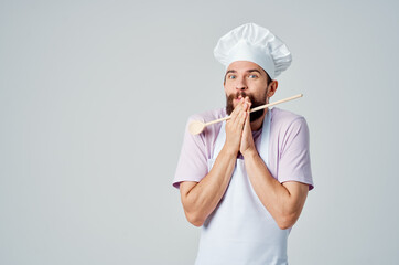 a man in a chef's uniform with a beard serving restaurant Professional