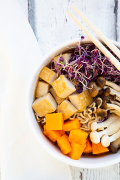 Miso Ramen soup with noodles, hokaido pumpkin, red radish sprouts, fried tofu, shimeji mushroom and king trumpet mushroom