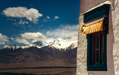 India, Ladakh, Window of Buddhist temple with Himalayas in background