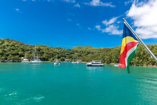 Seychelles, Praslin Island, Flag of Seychelles with marina in background