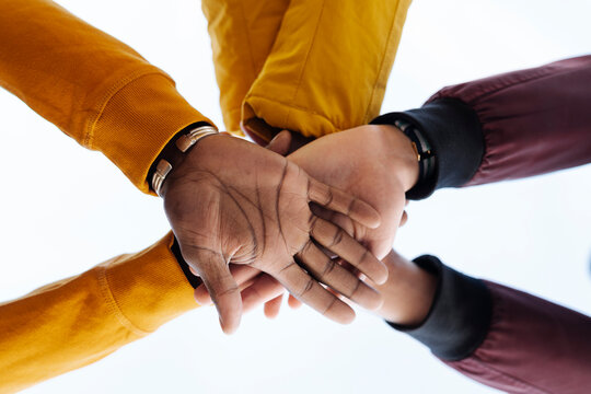 Close-up of friends stacking their hands