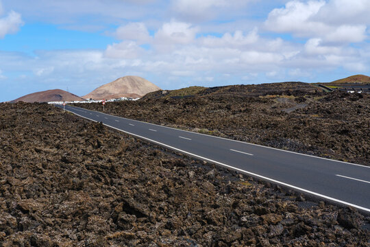 Spain, Canary Islands, Lanzarote, Mancha Blanca, Country road crossing lava field