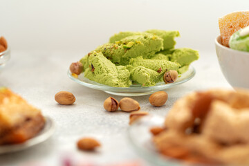Close up of colorful Turkish halva sweets on gray surface