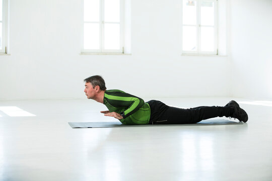 Man doing his fitness regime, practising yoga poses
