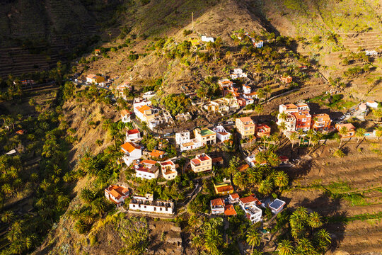 Spain, Canary Islands, La Gomera, Valle Gran Rey, Lomo del Balo, Aerial view of town in mountain landscape