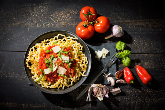 Pasta al Pomodoro, fusilli lunghi with tomato sauce, garlic, basil, parmesan cheese and red peppers